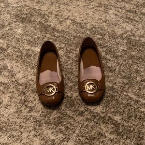 Women’s Michael Kors brown flats with gold emblem